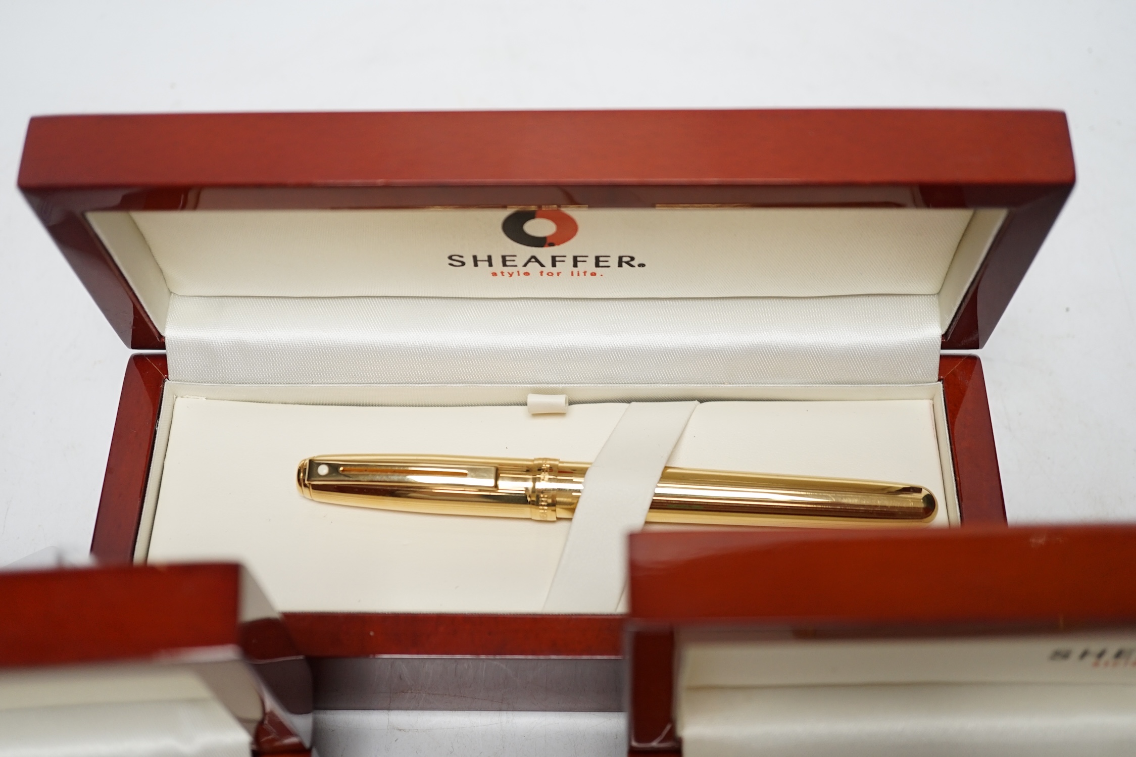 Three modern boxed Sheaffer fountain pens; an Imperial style pen and two others, all in stained beech cases